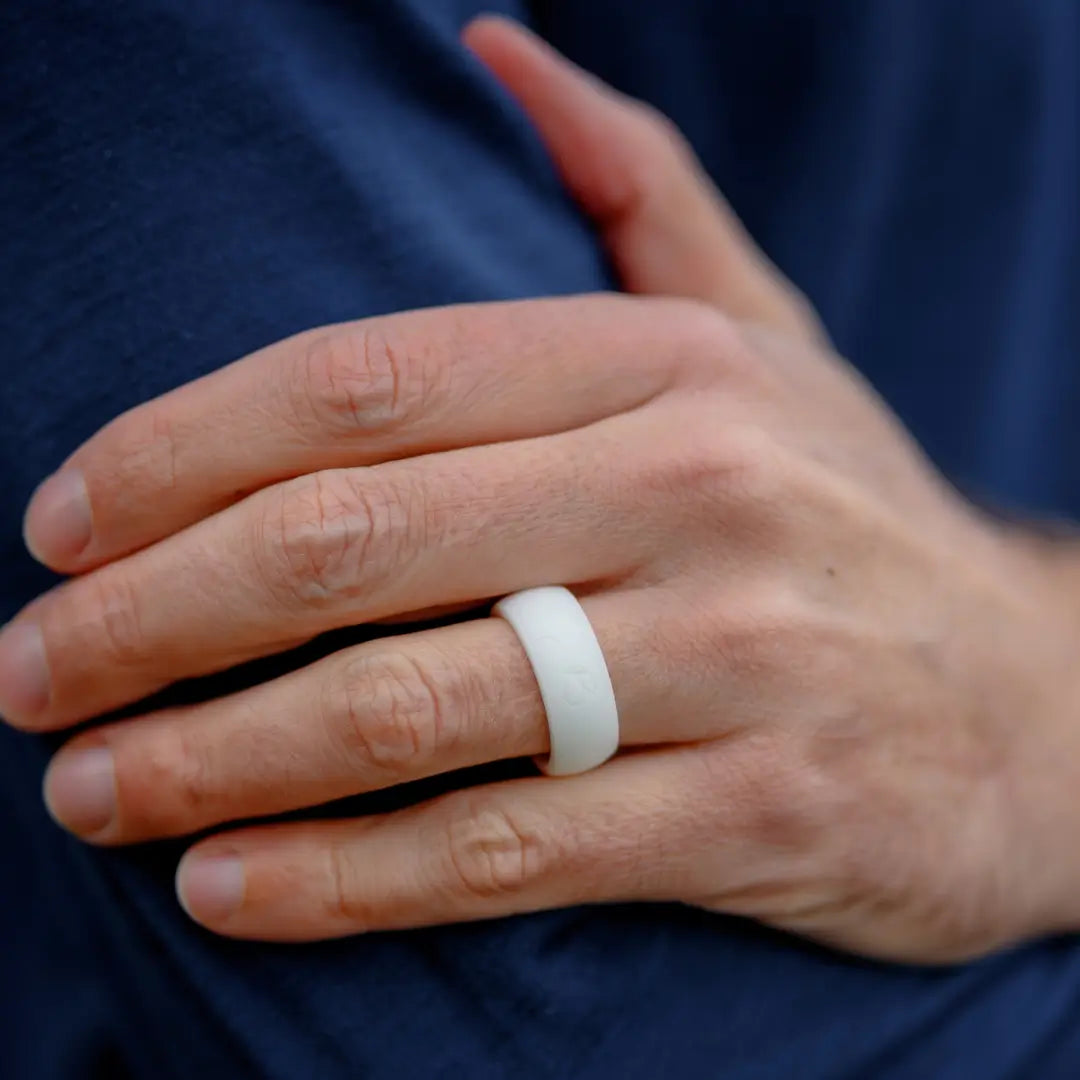 hand wearing botthms white silicone ring
